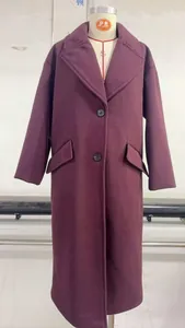 Detail view of wine red wool coat showing classic notched lapels and double-button closure