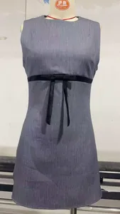Detail of grey sleeveless mini dress with a contrasting black satin bow waistband