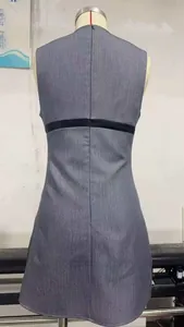 Detail of grey sleeveless A-line dress with black contrast waistband and hidden back zipper