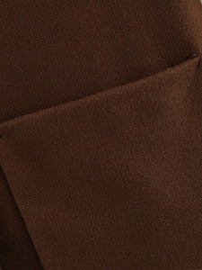 Close-up of deep brown wool coat showing textured fabric and pocket stitching detail