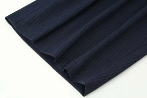 Detail of navy pinstripe fabric showing high-quality pleated texture and vertical stripes