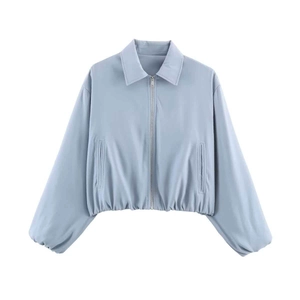 Detail view of light blue cropped jacket with silver zipper and elastic waist cuffs
