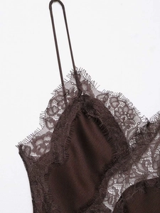 Detail of dark brown camisole dress featuring delicate lace trim and eyelash edges