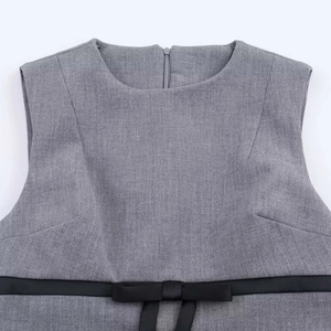 Sleeveless grey mini dress featuring a round neck and a black waist bow detail