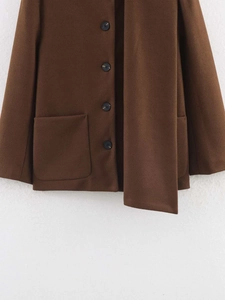 Detail view of brown wool coat featuring large patch pocket and single-breasted buttons