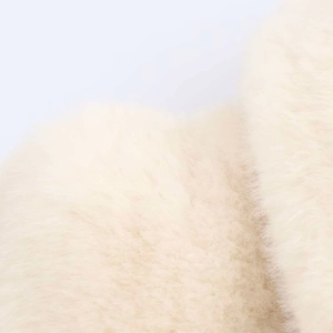 Macro shot of soft faux fur texture in cream beige with a luxurious silky finish