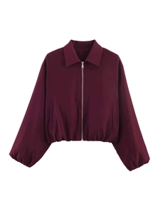 Detail view of burgundy cropped jacket with pointed collar and elastic hem