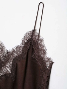 Macro detail of dark coffee satin camisole with delicate eyelash lace trim on neckline