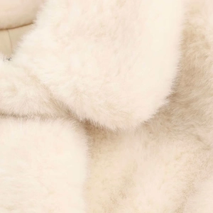 Close-up of soft white faux fur texture showing premium fluffy fibers on winter coat