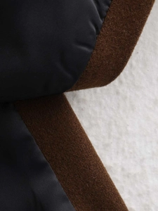 Detailed texture contrast of dark navy lining and premium brown wool collar fabric