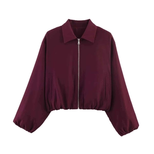 Close-up of burgundy short jacket with full front metal zipper and elastic hem details