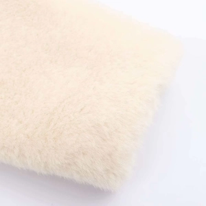 Detail shot of premium soft white faux fur texture showing thick plush fibers on a coat