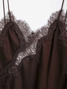 Macro shot of dark brown satin camisole featuring delicate black eyelash lace trim details
