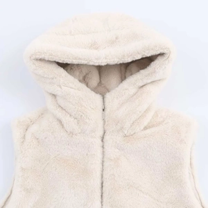 Dettaglio del gilet in ecopelliccia beige con cappuccio e morbida trama di peluche