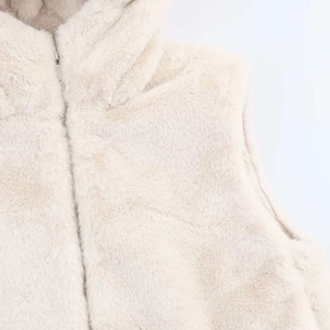 Dettaglio ravvicinato del gilet in ecopelliccia crema con collo alto e zip metallica