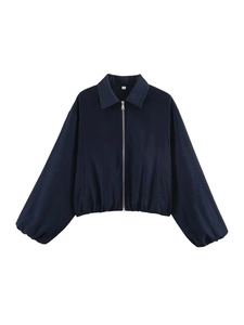 Detailed close-up of dark blue jacket with silver metal zipper and elastic hem design