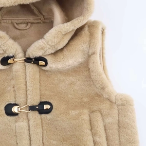 Detail of camel fleece vest showing hooded design and leather toggle closure with gold hardware