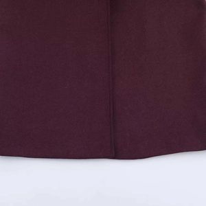 Close-up of premium burgundy wool fabric texture and neat stitching on a long coat