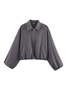 Detail of dark grey cropped jacket featuring elastic cuffs and smooth zipper closure