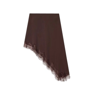 Detail of dark brown asymmetrical satin skirt with intricate lace trim at the hemline