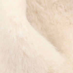Close-up of white faux fur material showing soft fluffy texture and high-quality fibers