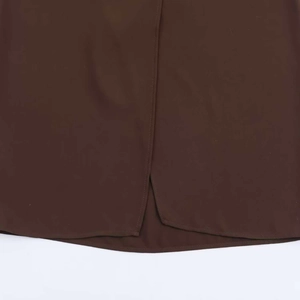 Detail of dark brown long dress featuring a bottom slit and precision stitching