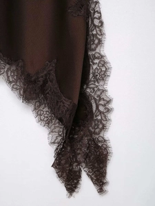 Detailed view of dark brown satin dress with intricate floral lace trim and silk finish
