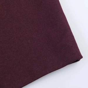 Close-up macro view of the dark burgundy wool blend fabric with thick woven texture