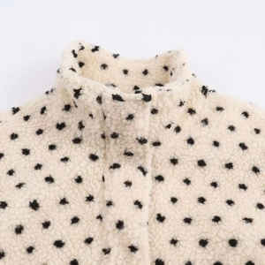 Chic cream sherpa fleece jacket with black polka dots and a stylish stand-up collar