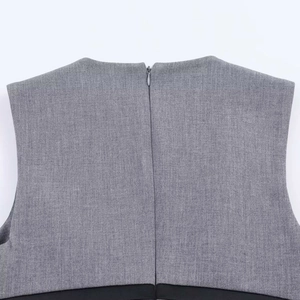 Detail of gray sleeveless dress featuring a back invisible zipper and black hem contrast