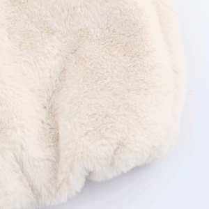 Dettaglio ravvicinato della finta pelliccia densa su un gilet alla moda bianco crema