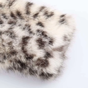 Macro shot showing high-density faux fur texture with detailed brown animal spots