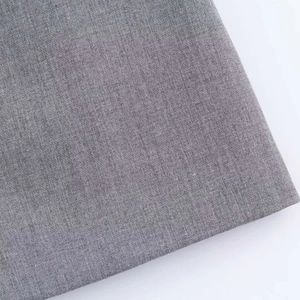 Detail of medium grey woven fabric showing high-quality smooth texture and fiber weave