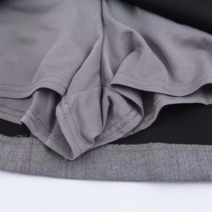 Detailed macro view of gray elastic inner lining and black hem with double-stitch sewing