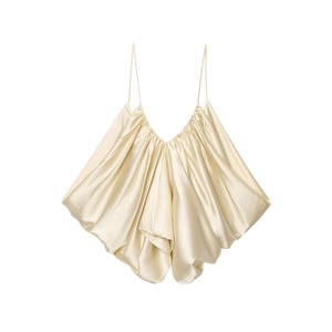Detail of champagne satin camisole featuring delicate pleats and a draped neckline