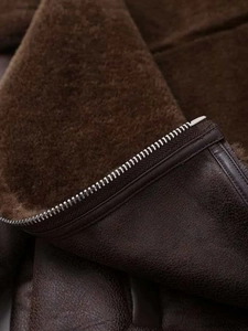 Detail of premium silver metal zipper on vintage brown faux shearling biker jacket