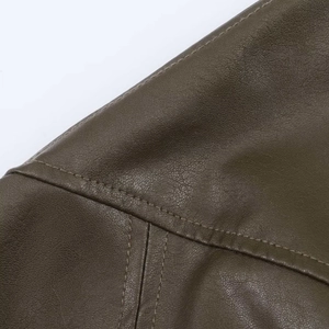 Detailed macro view of olive green faux leather texture and reinforced double stitching