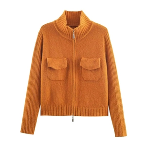 Detail of orange knit cardigan featuring high collar and dual flap chest pockets