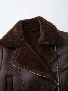 Detail of dark brown faux suede biker jacket featuring a wide plush faux fur collar