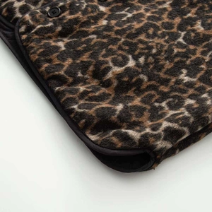 Close-up of leopard print vest featuring premium wool-like texture and matte black button