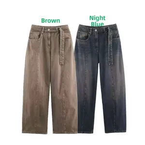 Detail showing high-waist wide-leg jeans with vertical seam stitching in brown and blue
