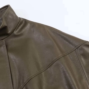 Macro view of high-quality olive green leather jacket collar and shoulder stitching details
