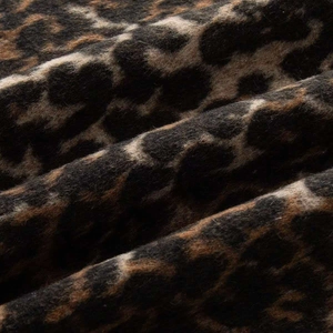 Detailed macro view of soft faux mohair fabric with a classic brown leopard print pattern