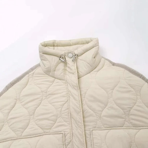 Women's cream quilted jacket with high neck and wave stitching design details