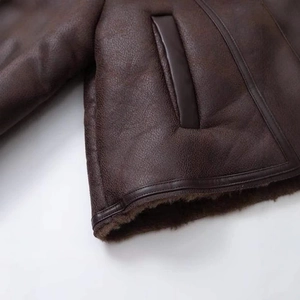 Short vintage brown faux shearling jacket with premium leather texture and side pockets
