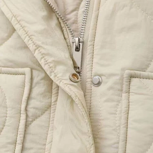 Women's beige quilted puffer jacket with stylish stand collar and high-quality metal zippers