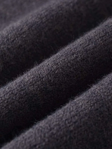 Macro shot of high-quality dark grey knitted wool blend fabric with soft fuzzy texture