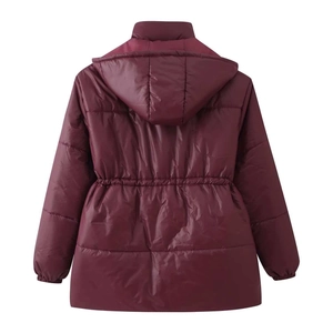 Detail of burgundy hooded puffer jacket featuring drawstring waist and horizontal quilting