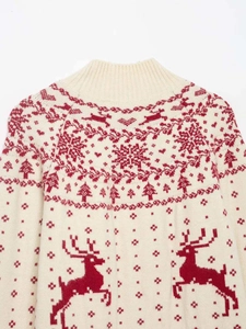 Detailed view of Christmas knit sweater with red reindeer and snowflake jacquard patterns