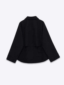 Detail view of the black wool jacket back showing layered storm flap and A-line silhouette
